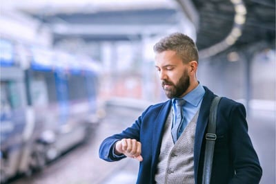 Businessman checking on time on his watch