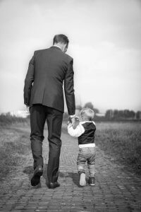 Businessman walking with baby